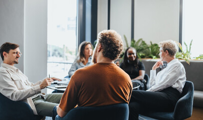 Business professionals having a meeting in an office, discussing and brainstorming as a team