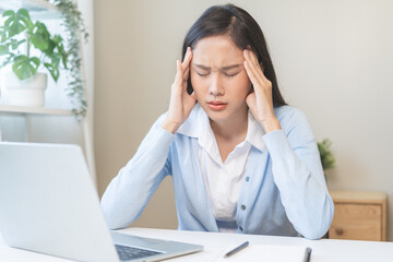 Stressed, exhausted asian young woman, girl pain from vertigo, having migraine symptoms headache, feel unhealthy, suffering from dizziness, holding head with hand. Health care problem of people.