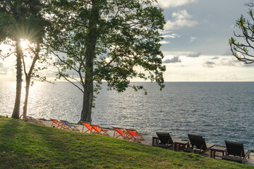Stunning landscape, sunrise blue sky view with clouds. Tropical resort hotel. Fantastic relax and peaceful vibes, chairs, loungers under umbrella and palm leaves. Luxury travel vacation