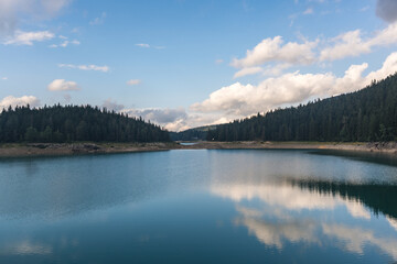 View of beautiful Black lake (Crno jezero) in National park Durmitor, Zabljak, Montenegro with turquoise water and trees. Scenic nature landscape