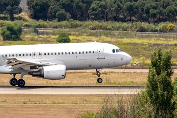 Close-up of a commercial airplane placing its landing gear on the runway during landing