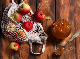 apple jam and fresh fruits on wooden background