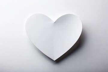 Fototapeta premium Isolated white paper heart on a clean white background, symbolizing love and affection, with ample copy space for text or message, perfect for Valentine's Day.