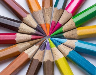 Fototapeta premium Circle of wooden color pencils lie in circle pointing to the middle