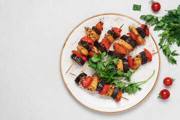 Chicken kebab, bell pepper, eggplant on plate. Fried meat with vegetables top view