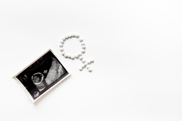 Ultrasound image of the baby and medicines. Pregnancy. Treatment of female infertility concept