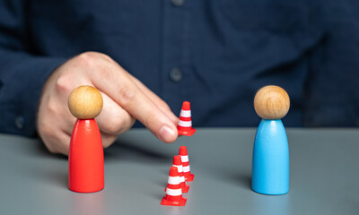 A man sets up a barrier of cones between people in conflict. Concept of the demarcation line. Freezing the conflict. Finding solutions. Reconciling the parties. Acting as a mediator.