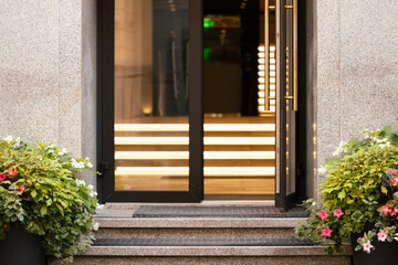 Hotel entrance outdoor facade exterior landmark close up local view door and stairs design with plants and soft electric light illumination framework background concept picture