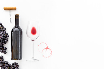 Bottle of red wine with bunch of grapes and wineglass