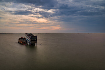 Lonely Shipwreck at Sunset