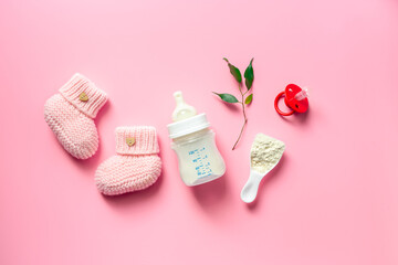 Kids flat lay with baby shoes and milk in bottle, top view