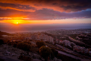 Fototapeta premium The scenic sunset over Mediterranean sea in Beirut, Lebanon capital, in the Lebanese mountains during the cloudy day. 