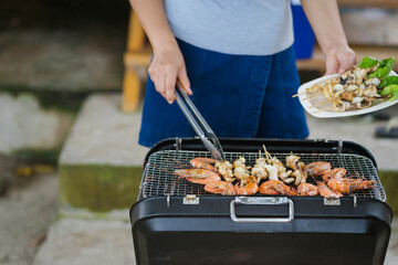 Portrait of a woman preparing food.