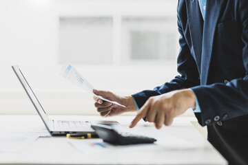 Businessman working inspecting documents is analyzing financial statistics data, Analysis business and investment charts, accounting finance. Accounting income and expense, planning financial budget.