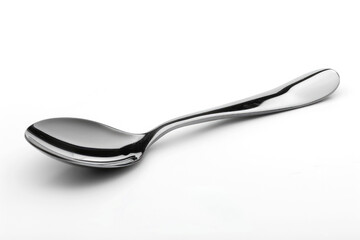 A silver metal spoon isolated on a white background.