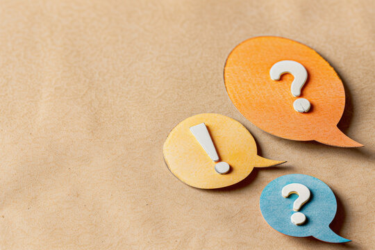 Colorful speech bubbles with question marks and exclamation marks on a textured background, representing communication and inquiry.