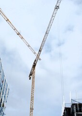 cranes criss crossing in the air