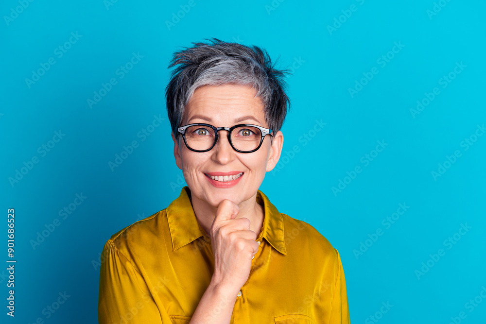 Poster Photo of pretty cheerful woman wear blouse spectacles arm hand chin emtpy space isolated blue color background