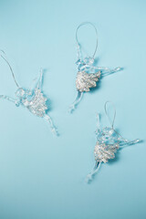 Three transparent ballerinas, Christmas decorations on a blue background