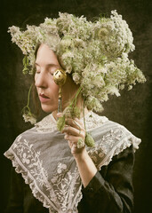 woman with bouquet of cow parsley on her head in romantic attitude with a teaspoon X