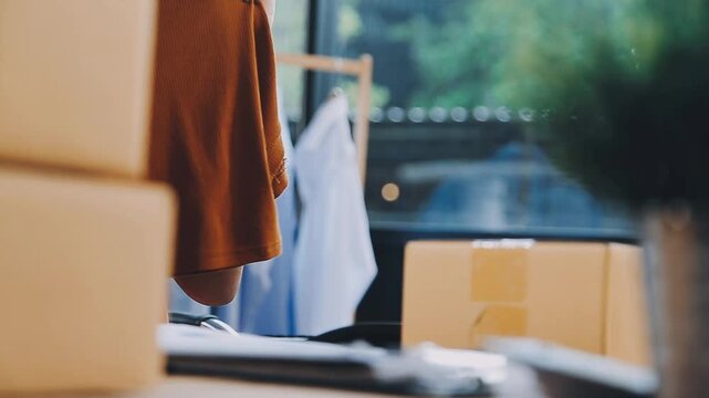 Designer concept.The dressmaker is designing an evening dress in the room.Asian clothing designers are measuring sample sizes to prepare evening gowns for important customer orders