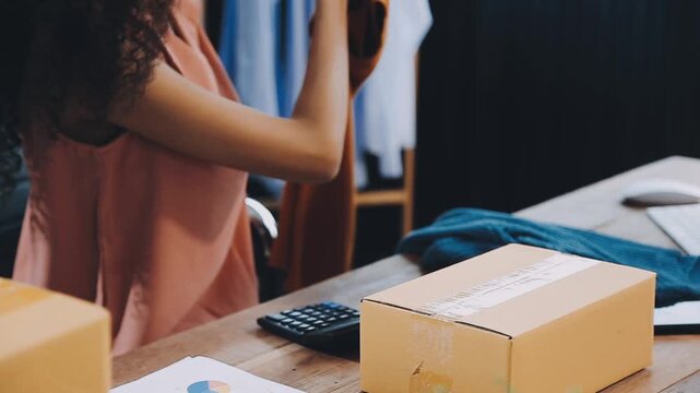 Designer concept.The dressmaker is designing an evening dress in the room.Asian clothing designers are measuring sample sizes to prepare evening gowns for important customer orders
