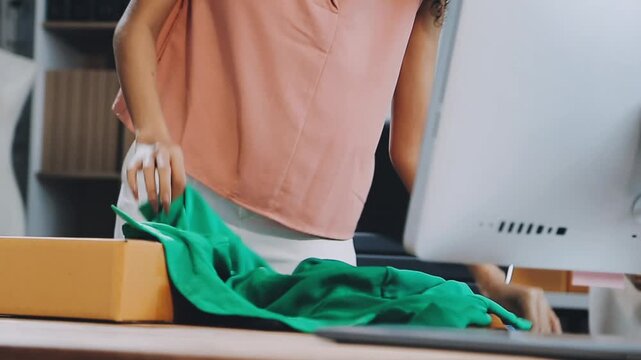 Designer concept.The dressmaker is designing an evening dress in the room.Asian clothing designers are measuring sample sizes to prepare evening gowns for important customer orders