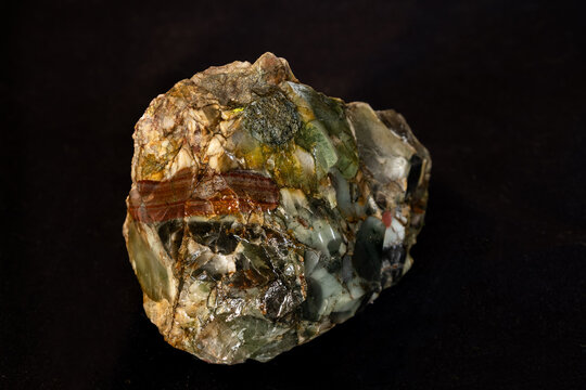 A chert conglomerate from the Fig Tree Formation of the Barberton greenstone belt against a black background