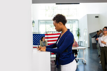Woman standing in voting booth, voting. Concept of USA elections, patriotism, support