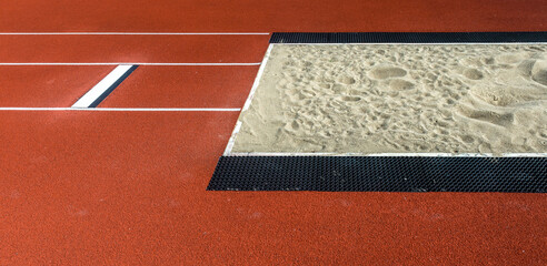 Long jump pit in a stadium. Horizontal sport theme poster, greeting cards, headers, website and app