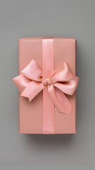 A pink box with a pink ribbon tied around it
