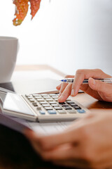 Close up of woman using calculator doing math finance in the office, tax, report, accounting, statistics, and analytical research concept
