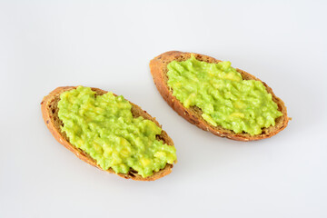 slices of bread with guacamole isolated on white background 
