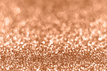 Peach sparkling glitter bokeh background, abstract defocused texture. Holiday lights