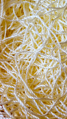 Close up golden beige yarn thread as abstract background