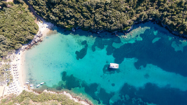 Aerial drone photo of luxury sail boat anchored in paradise bay of Ornos in island of Mykonos, Cyclades, Greece