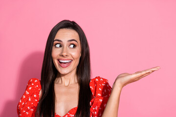 Photo of brunette charming young lady in red glamour vintage blouse holding arm product looking excited promo isolated on pink color background