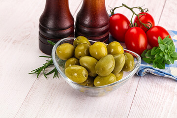 Green marinated olives in the bowl