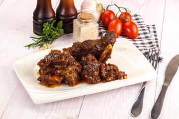 Prepared tasty beef ribs with sauce