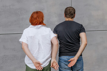 Happy dancers curling in dance in city. Romantic couple, woman with red hair and man in dark...