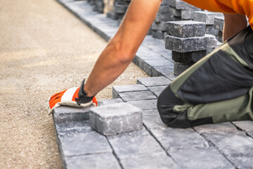 Laying Paving Stones on a Pathway in Bright Daylight