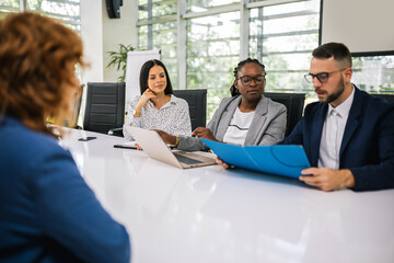 Fototapeta premium Human resource having a pleasant talk with a young female applicant in a relaxed atmosphere during an interview for a job.