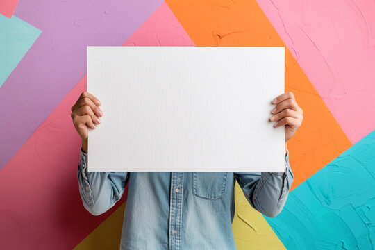 Simple photo of a person holding a blank canvas, representing potential for creative expression 