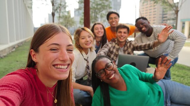 Group of international friends having fun, gesturing and looking at camera together. Student people smiling on a friendly meeting outside. Young teenagers bonding and celebrating on a social gethering