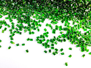 Clear green masterbatch granules, isolated on white background. Color pigment carrier polymer in the plastics industry