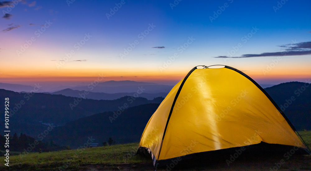 Wall mural Adventurer tent during overnight camping site at the beautiful scenic sunset view point over layer of mountain for outdoor adventure vacation travel