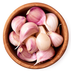 Fresh unpeeled garlic cloves in rustic wood bowl isolated on white from above.