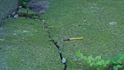 Glass Syringe Filled with Liquid Psychoactive Substance Narcotic Dropped on Ground in Dangerous Shabby Neighbourhood Alley
