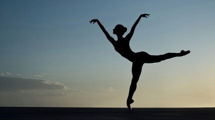 Fototapeta premium Ballet Dancer Performing Arabesque Against Sunset Sky