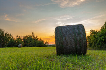 Sunset and hay on green meadow near nuclear power plant in summer evening © luzkovyvagon.cz